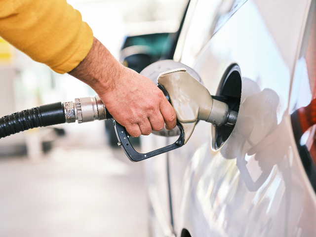 Fuel pump attendant putting fuel into ICE car