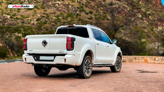 Rear view of the GWM P500 2.0T HEV Ultra Luxury 2024 model parked in a scenic outdoor setting