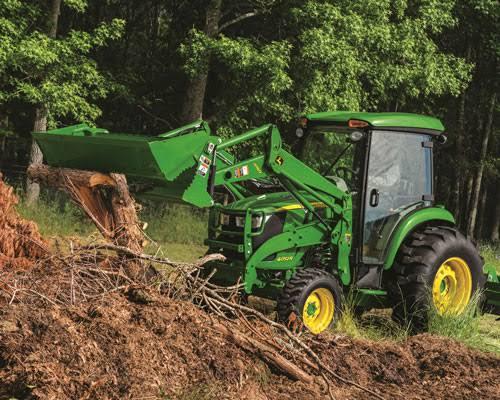 The image depicts a green tractor equipped with a front loader attachment.