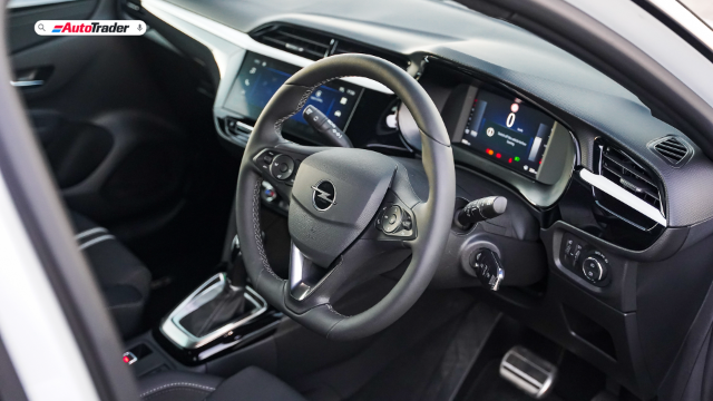 Interior of a white Opel Corsa GS showing the steering wheel and dashboard