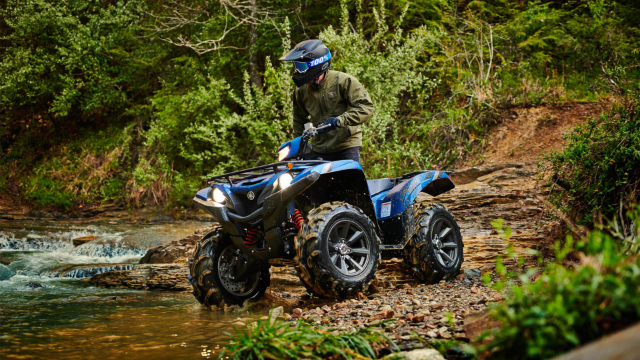 Yamaha YFM 700 Grizzly ATV riding offroad in woods