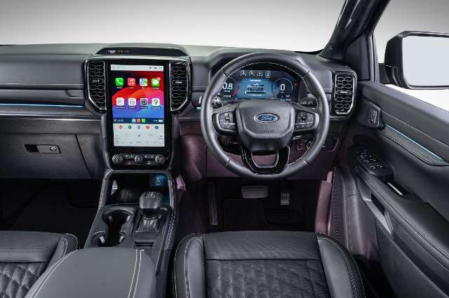 A closer view of the touchscreen and steering wheel.