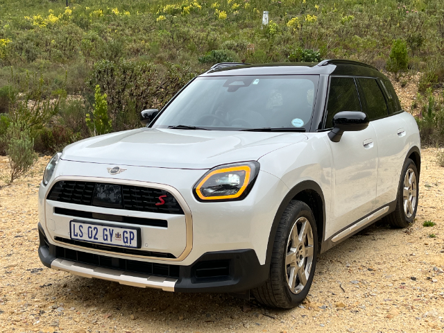A white MINI Countryman parked on gravel.