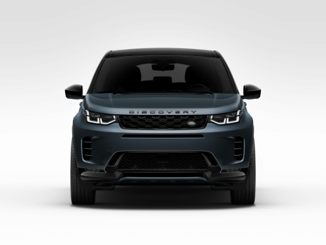 Front view of a Land Rover Discovery Sport in a studio setting, showcasing its sleek design, prominent grille, and modern headlights. The vehicle is dark-colored with a glossy finish, and the word "DISCOVERY" is prominently displayed on the hood.