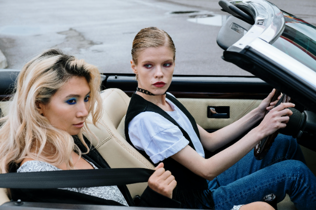 Two girls in a convertible.