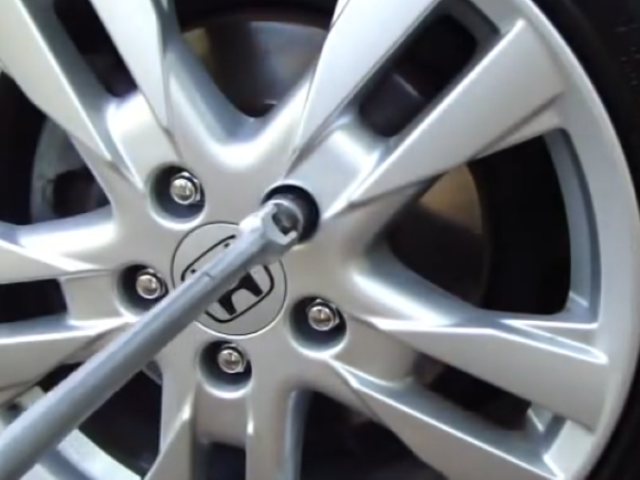 wheel nuts being removed on car wheel 