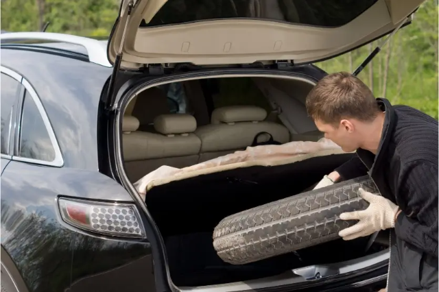 placing a tyre in the boot of a car