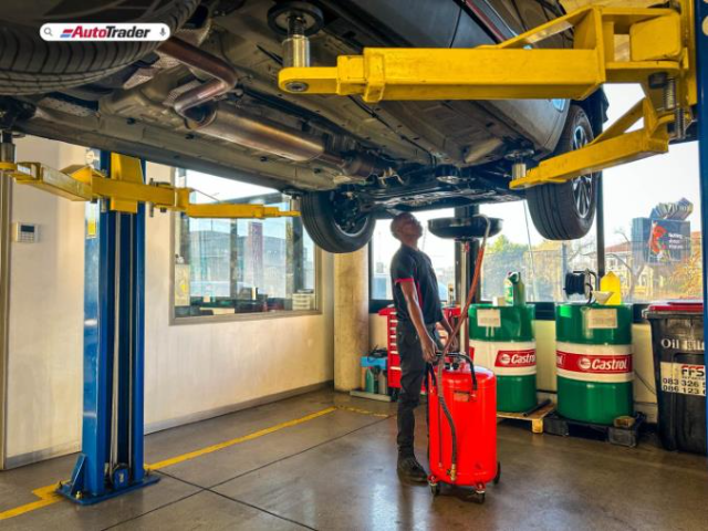 Technician changing vehicle oil