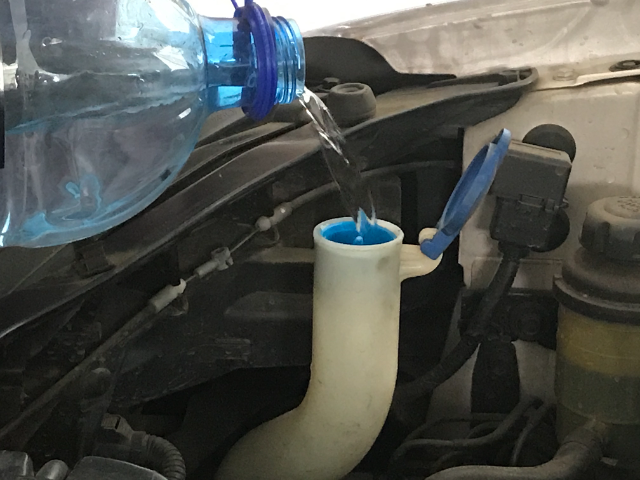 washer fluid reservoir in a car