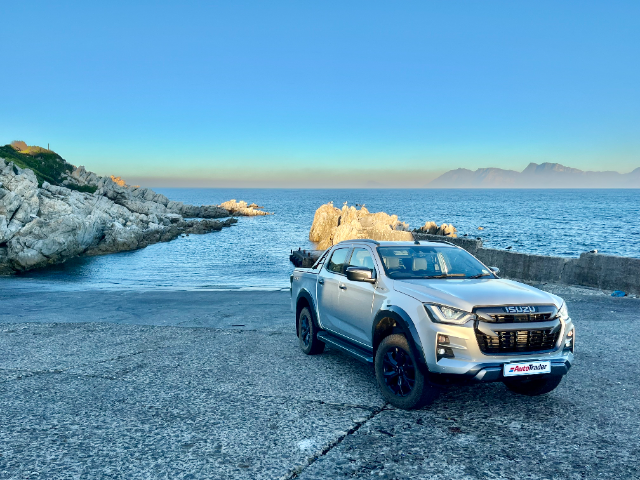 A V-Cross bakkie at sunrise, with the ocean in the background.