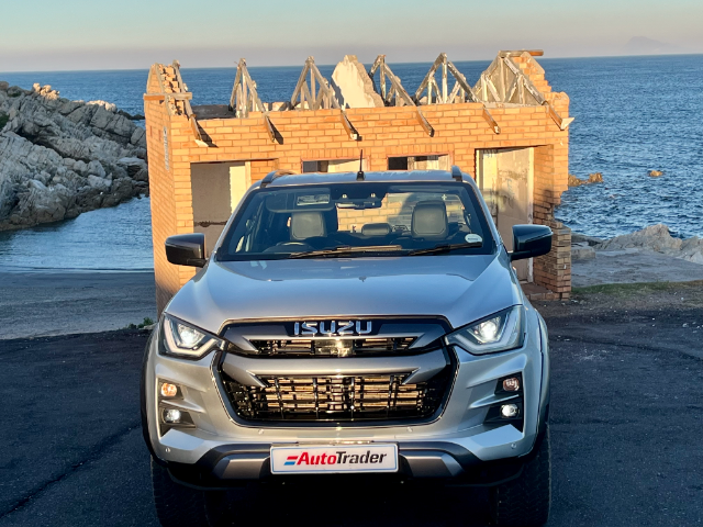 Full frontal view of the silver V-Cross model with a half-built house in the background.