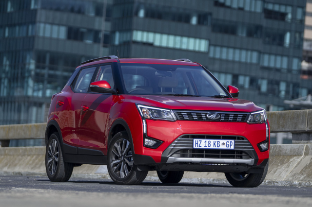 A red XUV300 on the road.