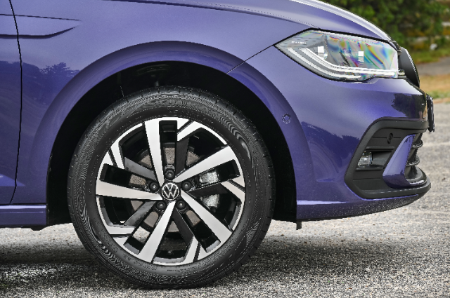 The wheel of a blue VW Polo