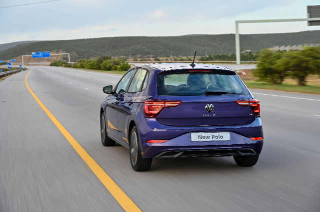The rear end of a blue Polo.