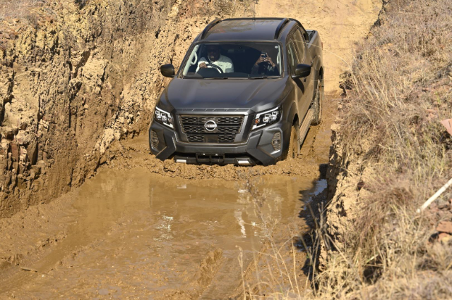 The Navara Stealth taking on a steep decline, mud, and water, all at the same time.