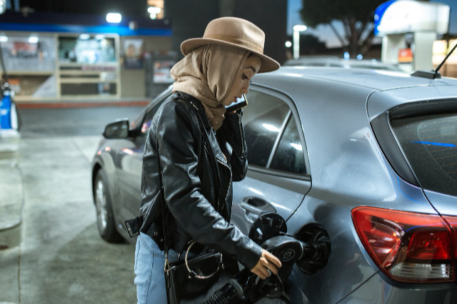 Lady pouring petrol