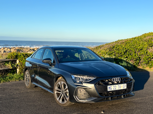 The A3 sedan next to the ocean.