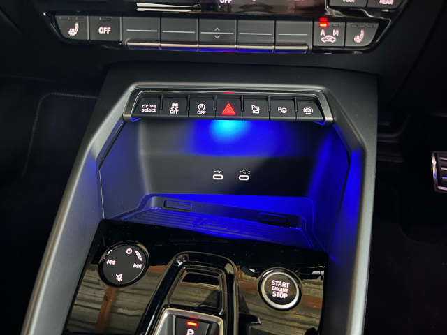 Blue ambient lighting above the charging pad.