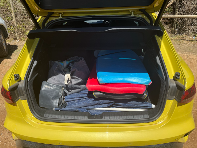 The fully stacked boot of the yellow Audi A3 hatch.