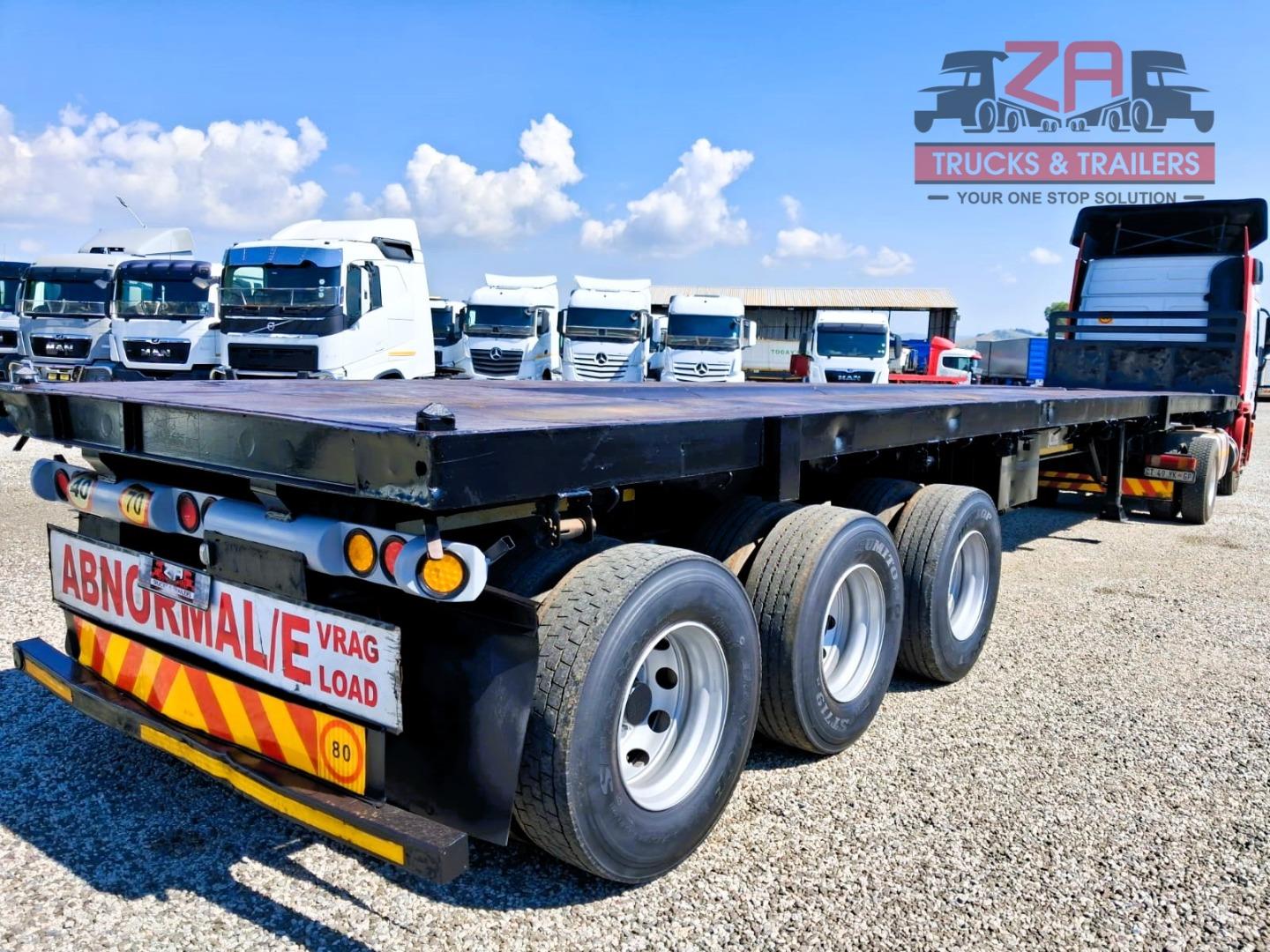 TOP TRAILER TRI-AXLE FLAT DECK *BARGAIN DEAL! Za Trucks and Trailers