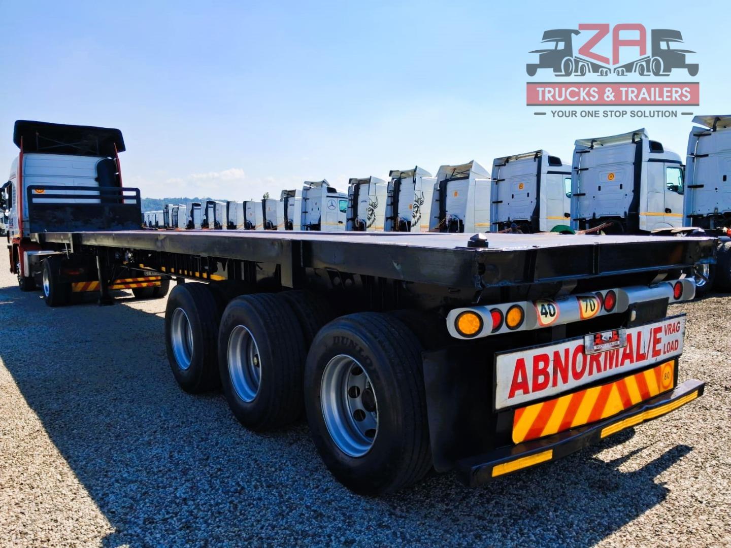 TOP TRAILER TRI-AXLE FLAT DECK *BARGAIN DEAL! Za Trucks and Trailers
