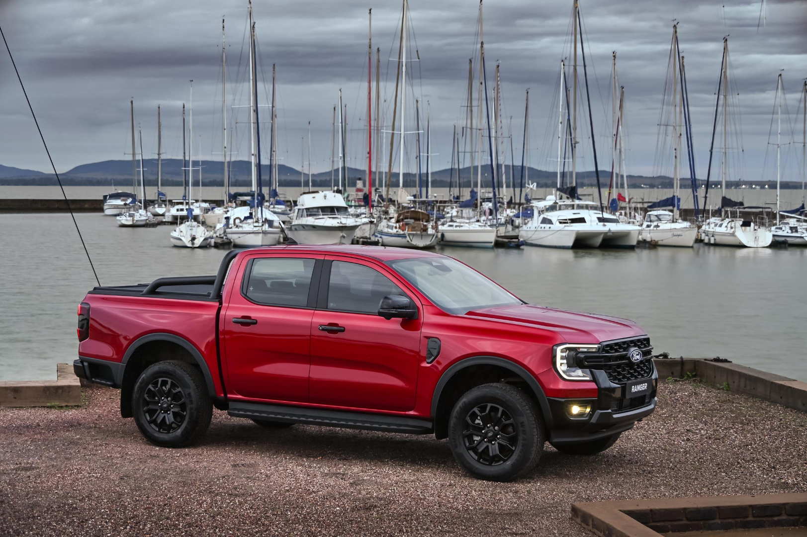 New Ford Ranger Sport 2.3T at a harbour with yachts in the background.