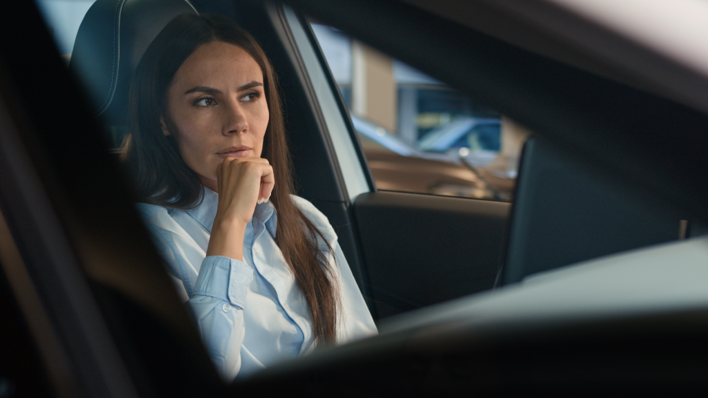 Pensive woman in car.
