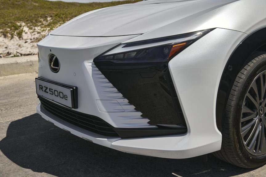 The sharply styled front end of the Lexus RZ with contrasting panels and angular lights.