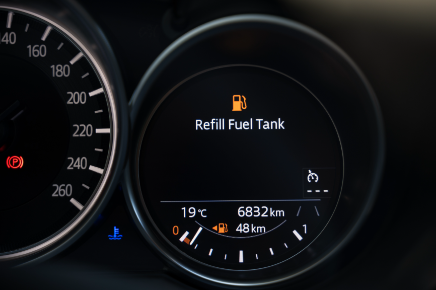 The fuel gauge of a car showing it's empty.