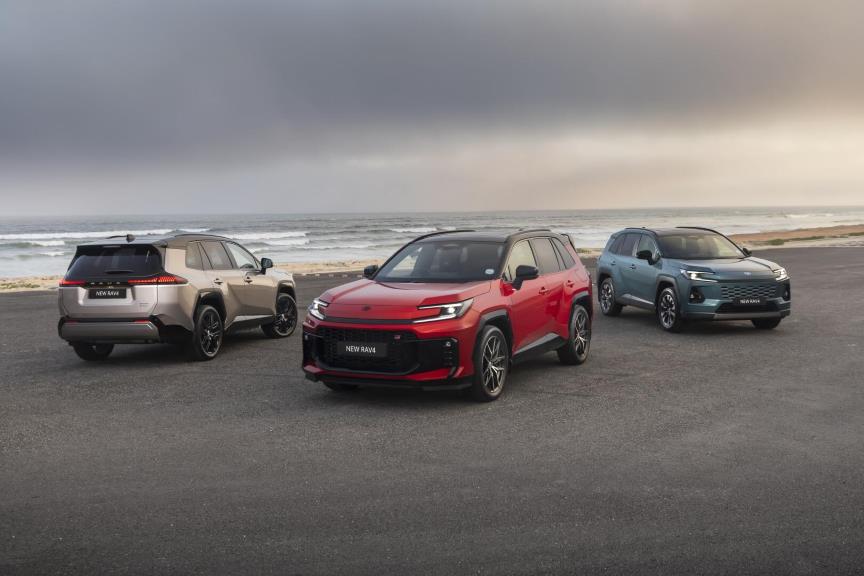 Three new RAV4  models parked on a beach at sunrise.