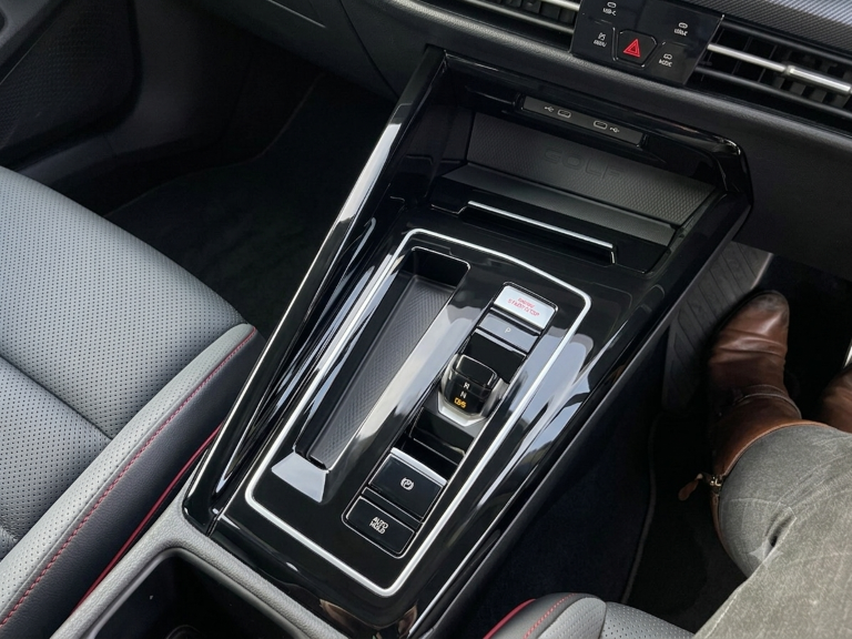 The Golf GTI's gear lever, start button, charging pad.
