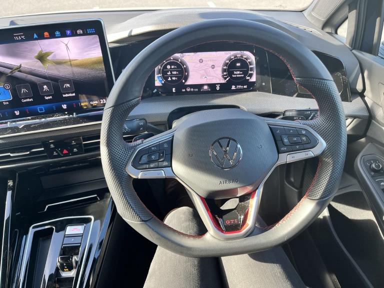The steering wheel, digital display and general cockpit layout of the Golf GTI.